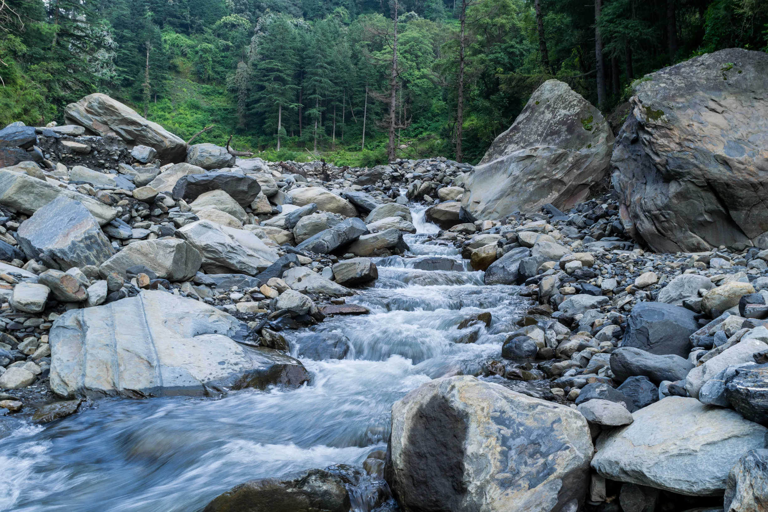 A remote Himalayan village trail winding between stone houses and peaks